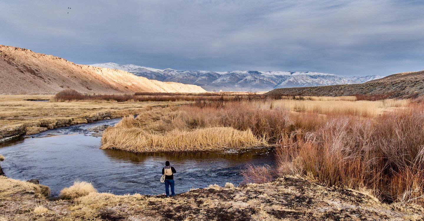 person fishing on the Owens River during winter