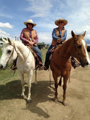 image: two women on a mule and a horse