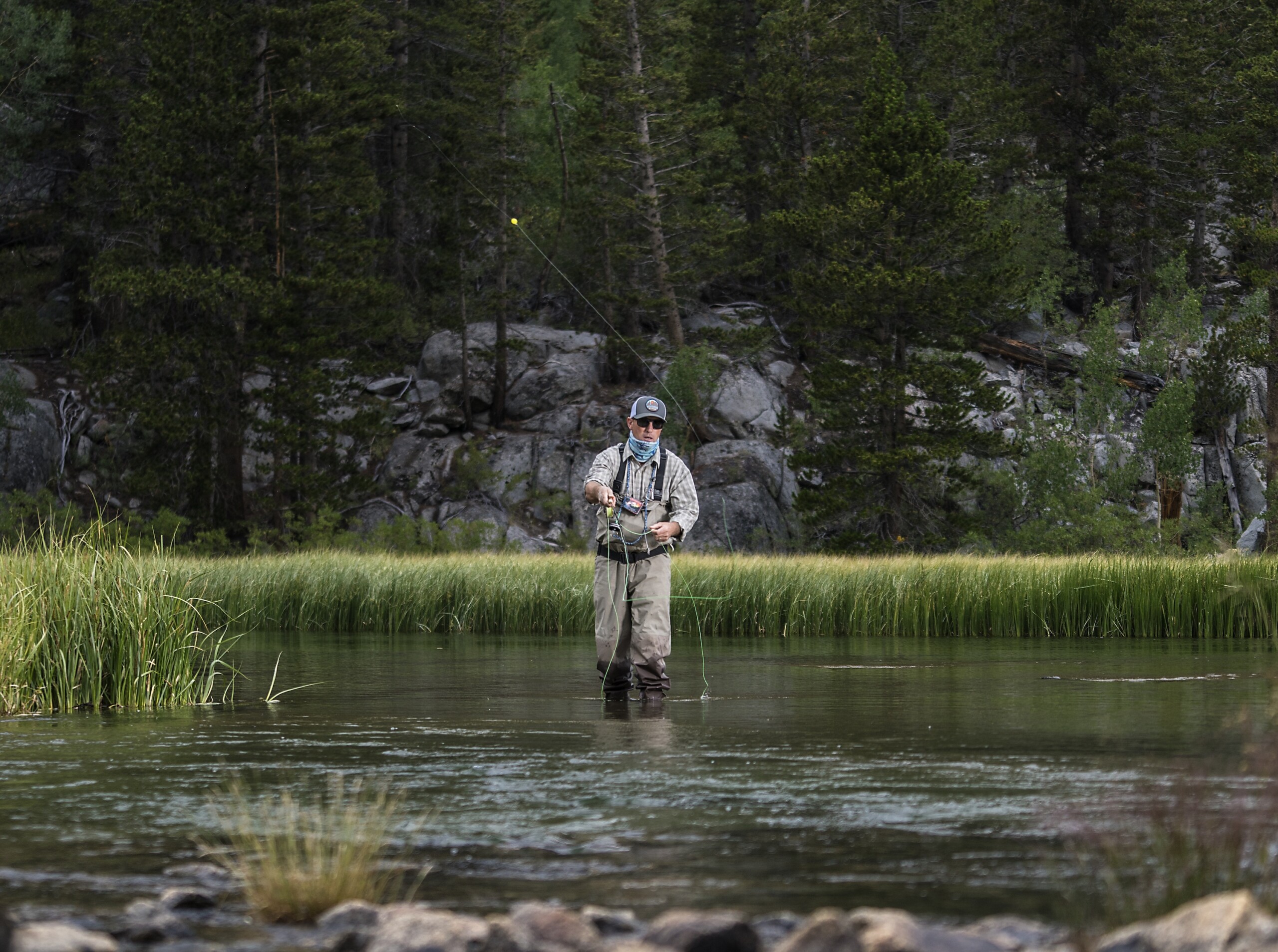 fisherman fly fishing in the fall in the Eastern Sierra