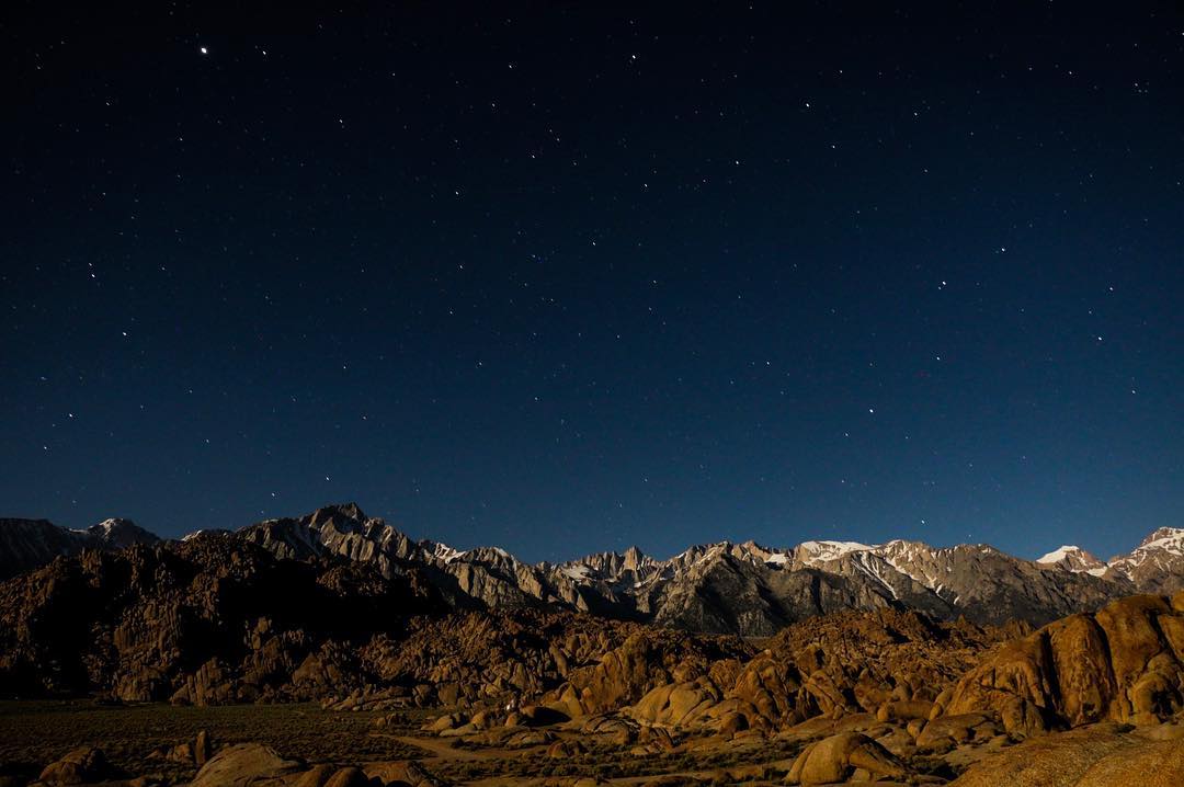 The Sierra at dusk with the stars above them