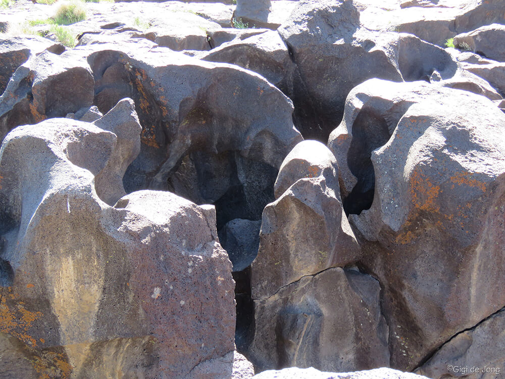 smooth rounded black rocks that were shaped by water