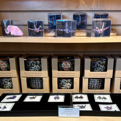 Handmade origami pins, earrings, pendants, and bowls at Manzanar gift shop.