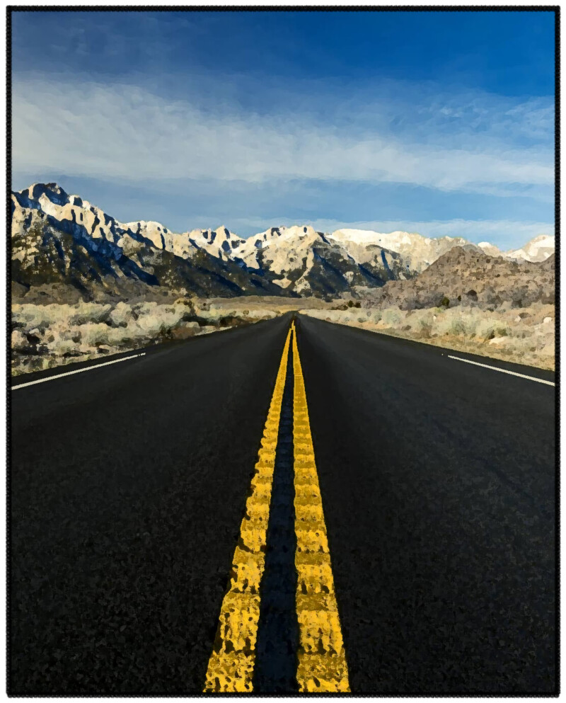 Empty road with yellow lines leading to a snowy mountain range under a blue sky with light clouds. visit bishop