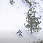 A person skiing down a snow-covered slope in the Eastern Sierra, surrounded by picturesque trees near Bishop, California. visit bishop