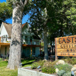 Eastside Guest House among large trees near a cottage on the grounds. visitbishop