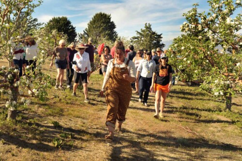 Rachel Kulchin touring the orchards at the Blue Heron Project